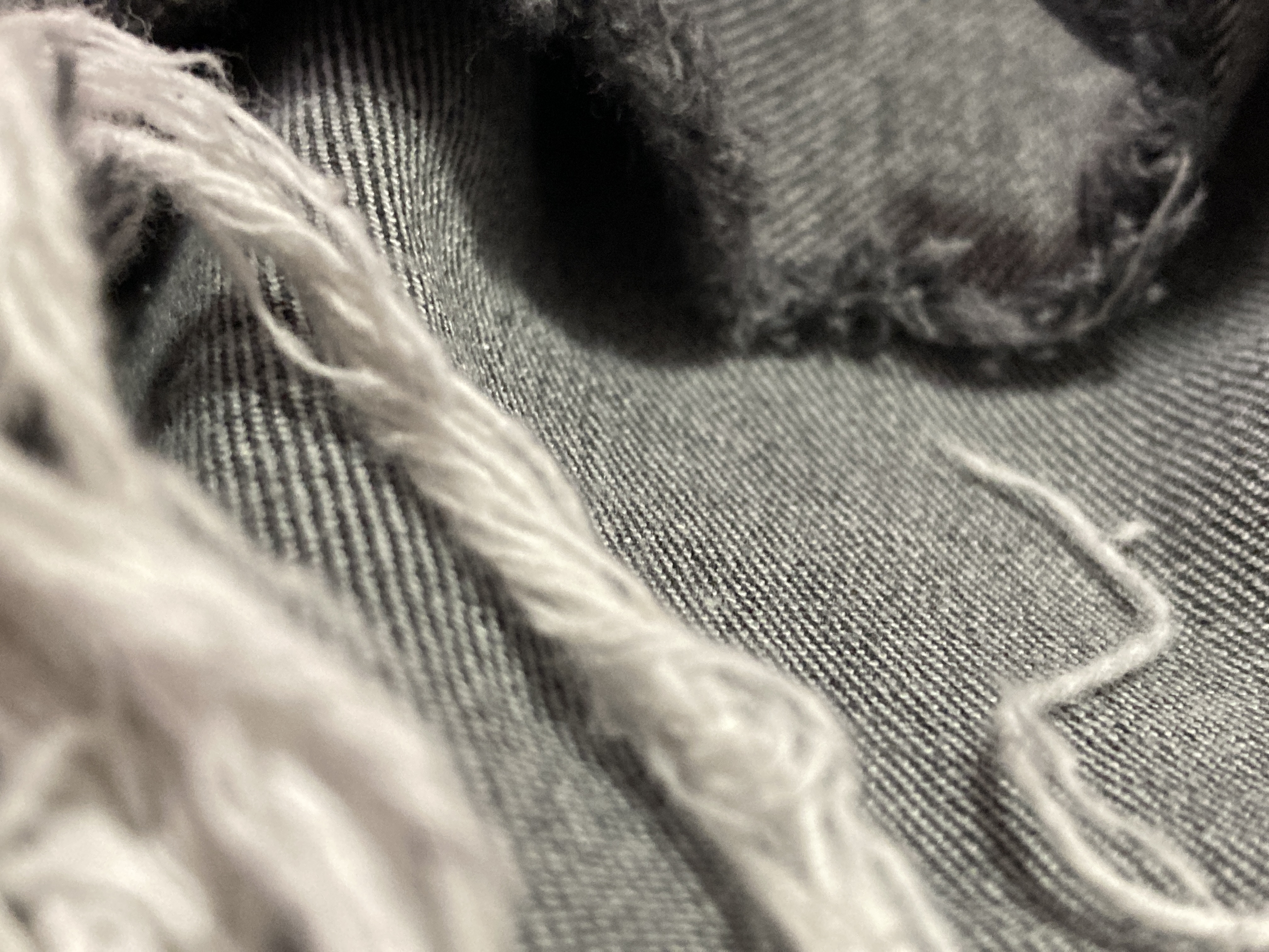 A whole in some torn jeans.