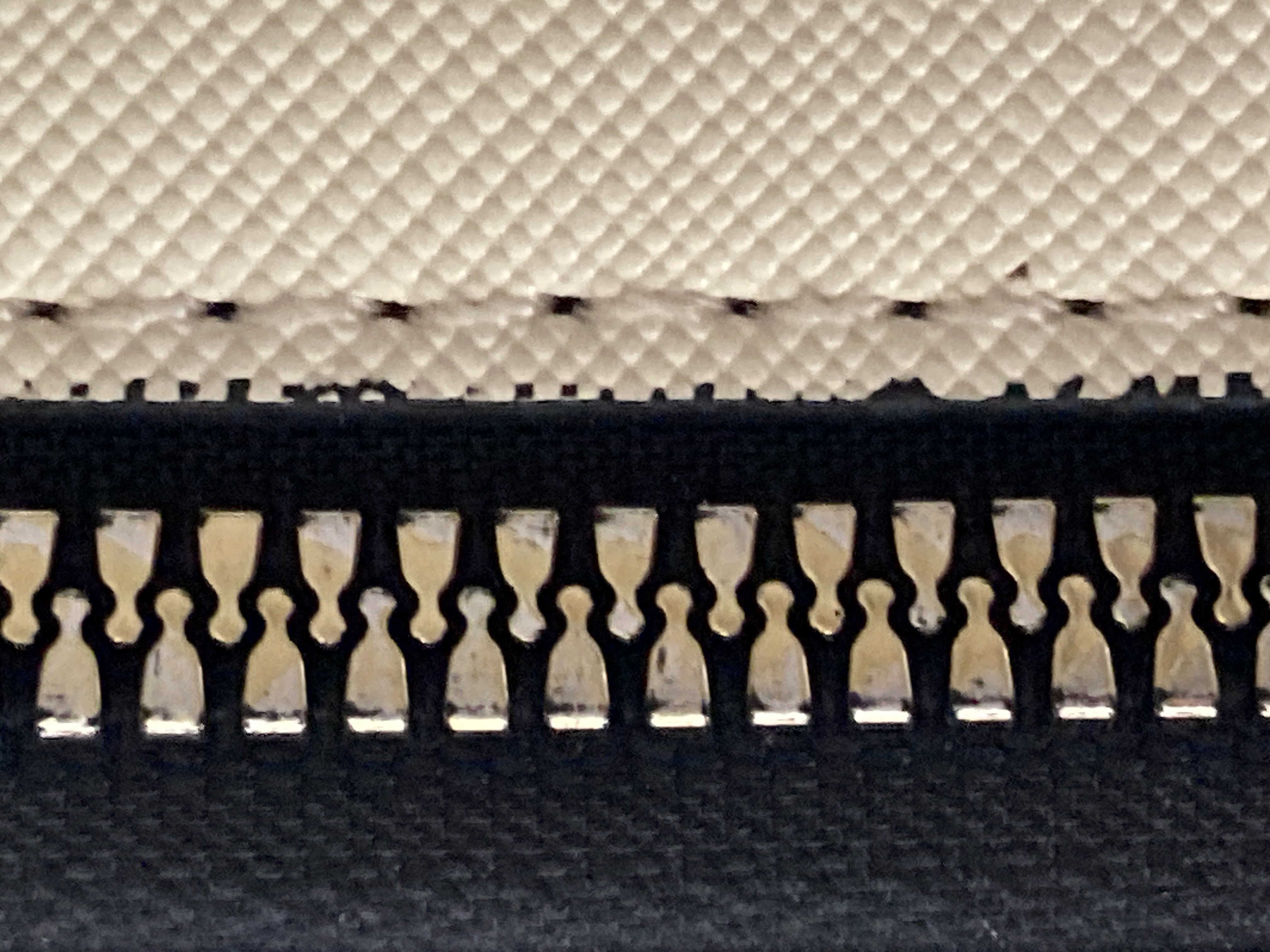 The zipper of a bag.